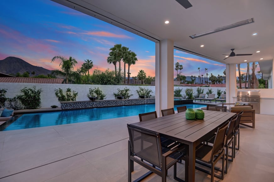 COVERED PATIO TO POOL AND PALMS DUSK